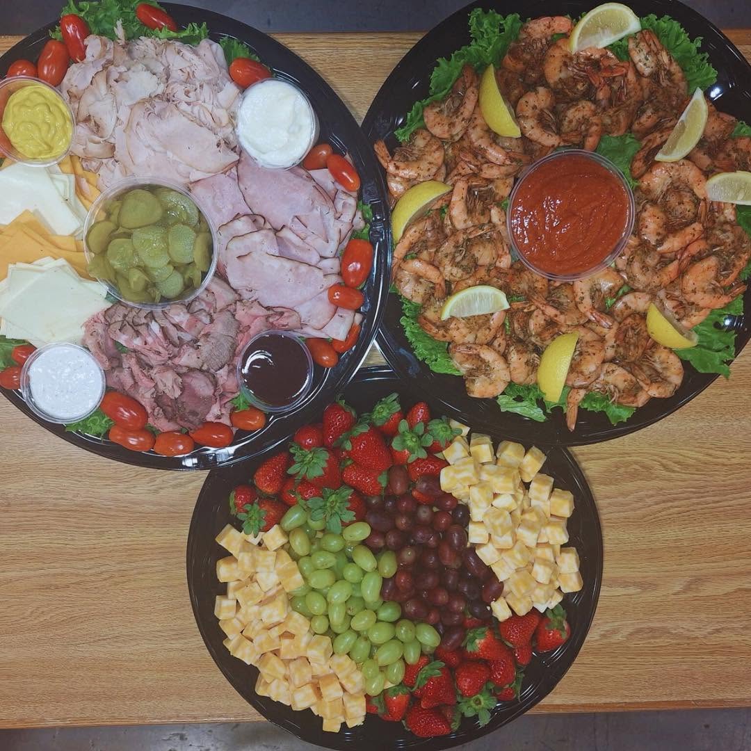 Catering party trays with shrimp, fruit, and cheese